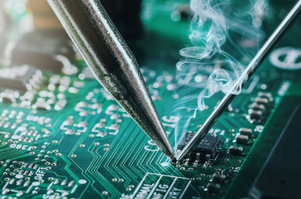 Hand soldering electronic components on PCB